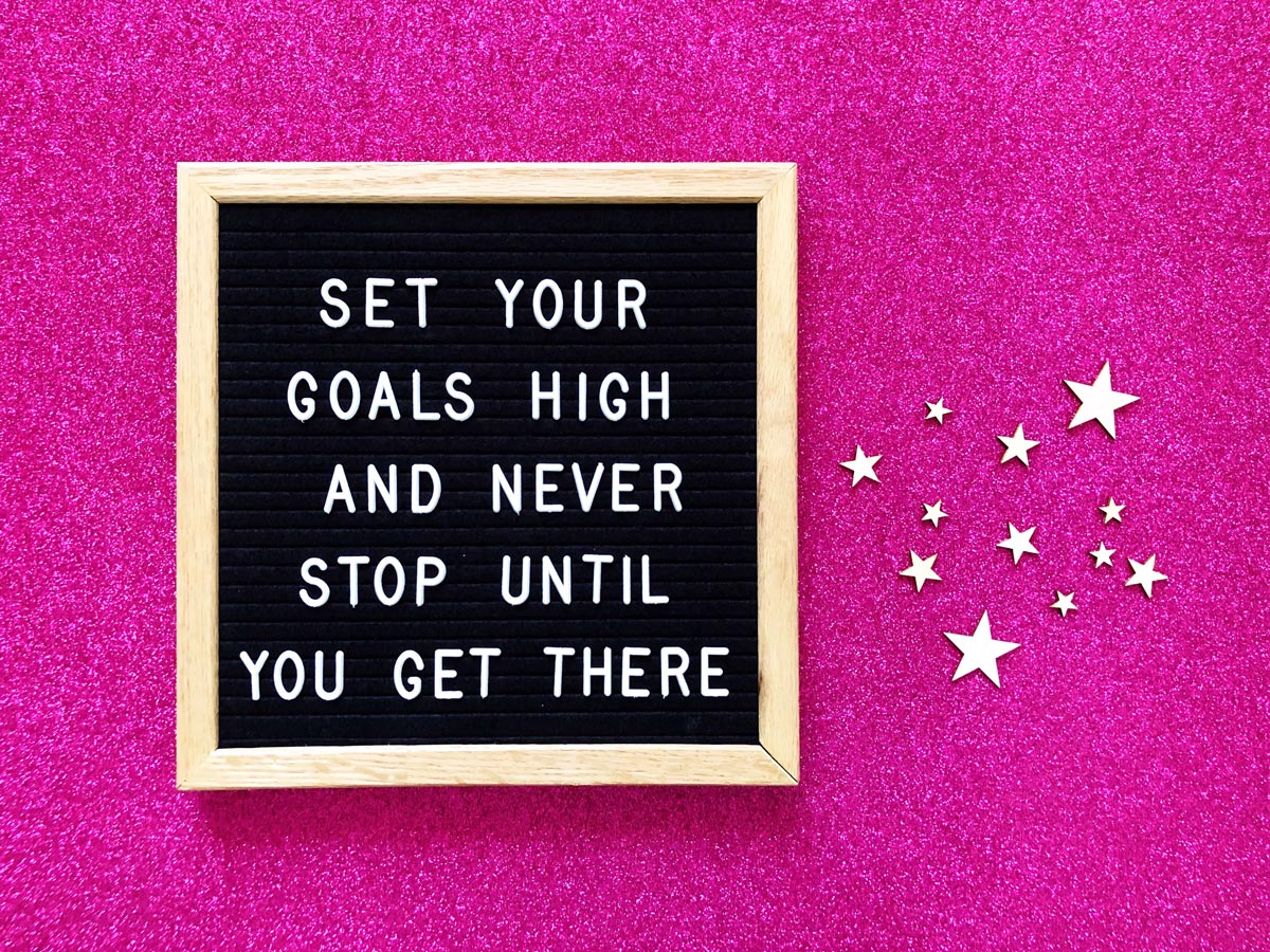 A felt board with push in letters with the phrase “set your goals high and never stop until you get there