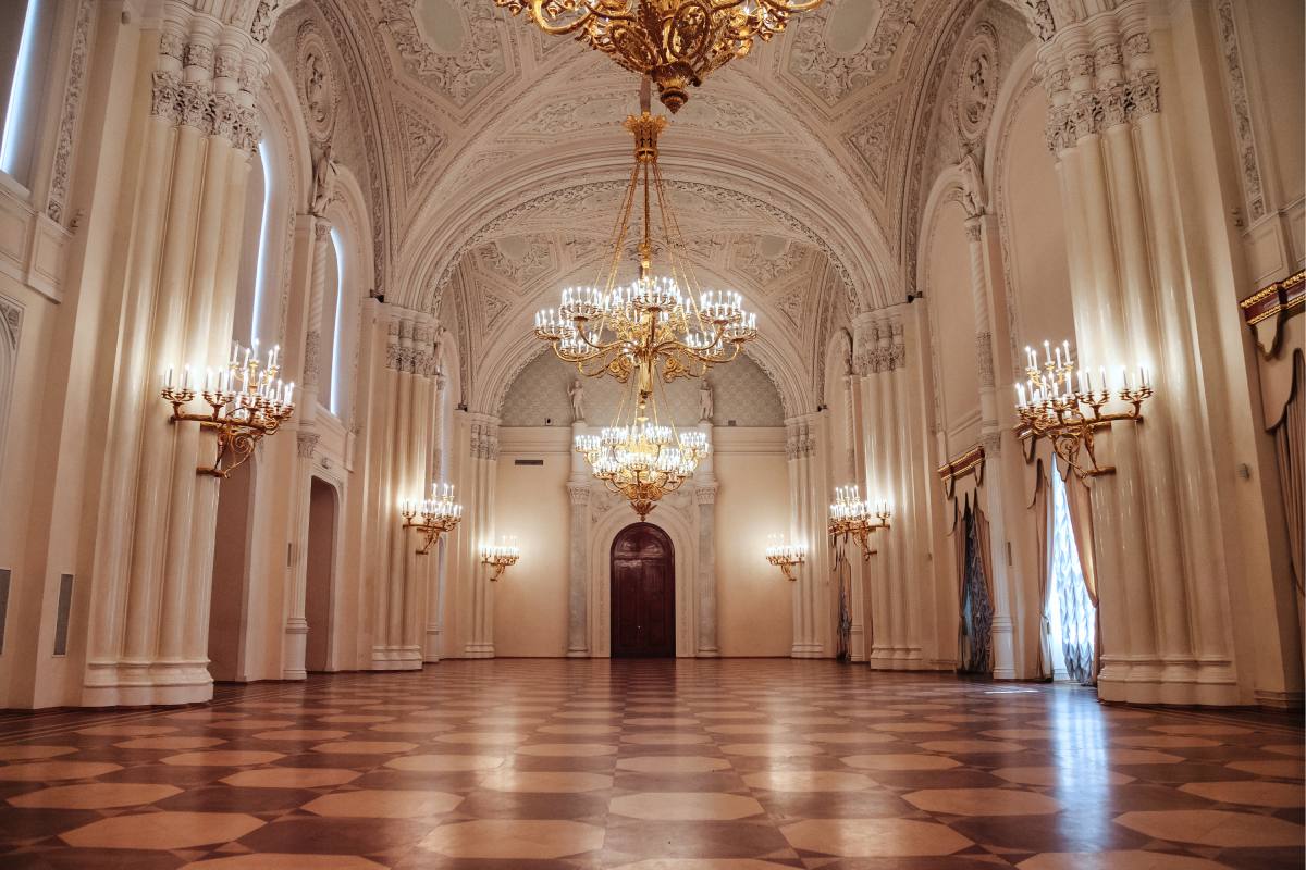 A large empty elegant ballroom with chandeliers