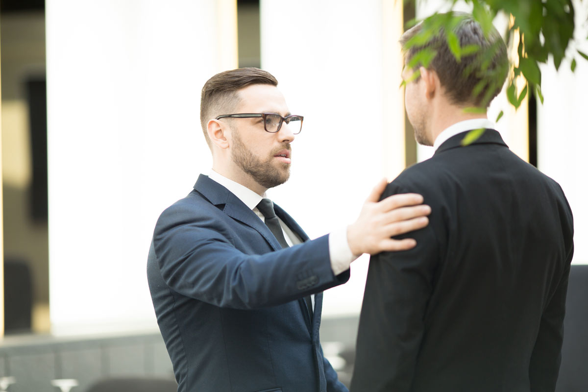 White 30-something best Man with glasses encouraging the white groom on his wedding day. 