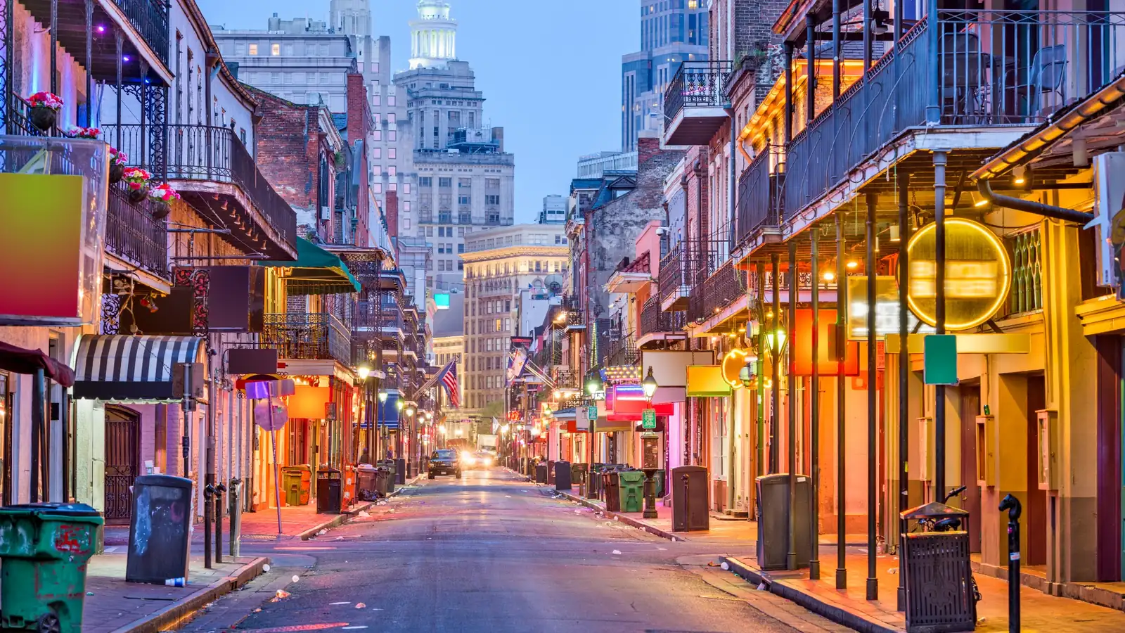 Colorful Bourbon Street scene in New Orleans with glowing balconies, neon lights, and historic French Quarter architecture