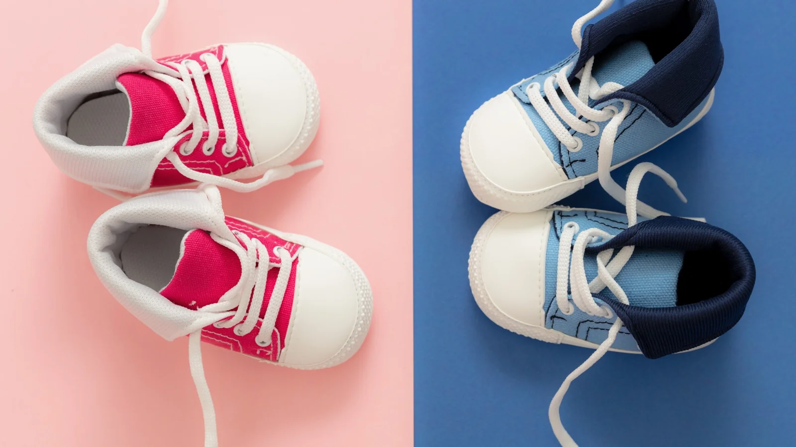 Pink and blue baby sneakers on split pastel background representing a sports-themed baby shower for boys and girls