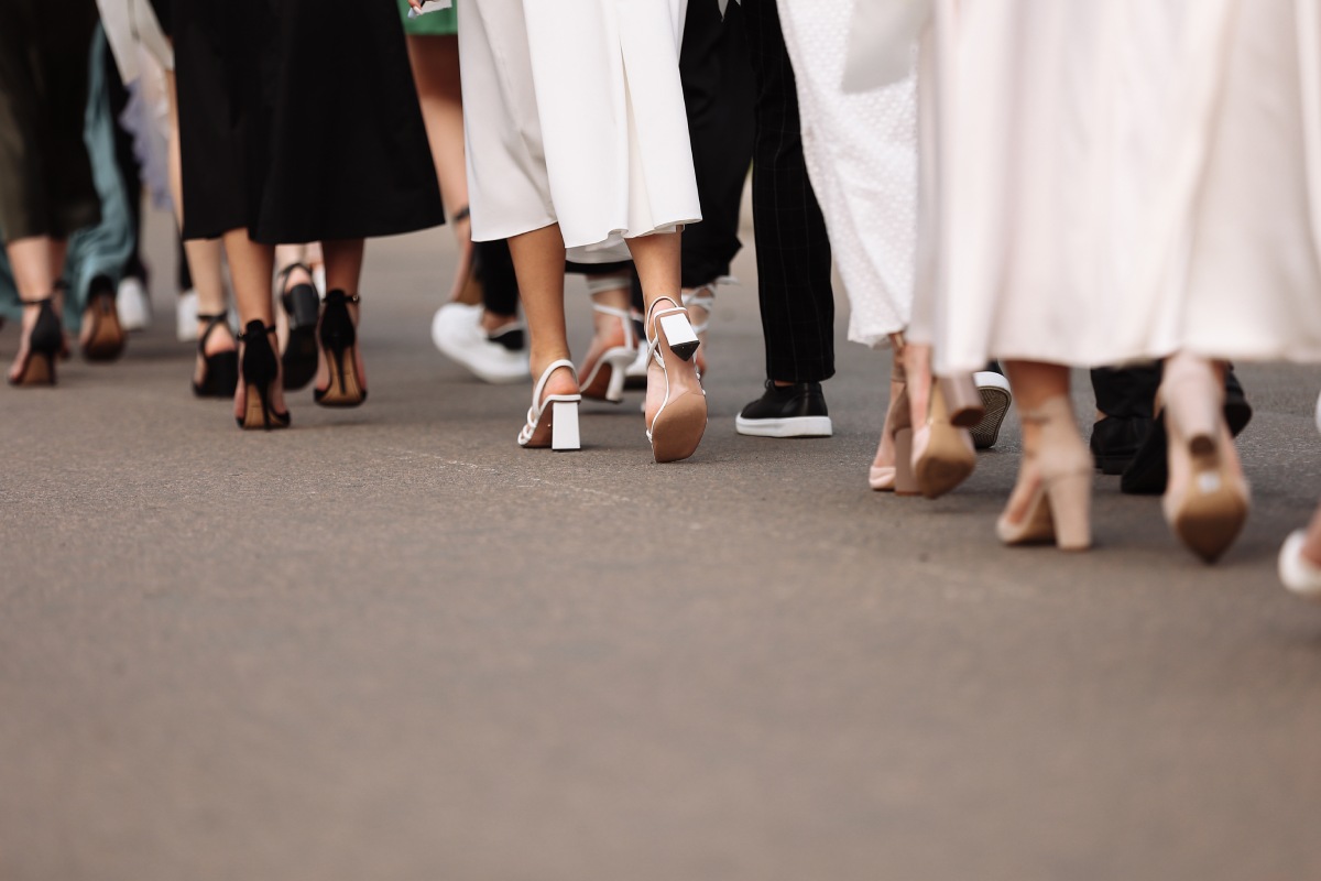  Line of people walking away from the knees down wearing heels and formal wear