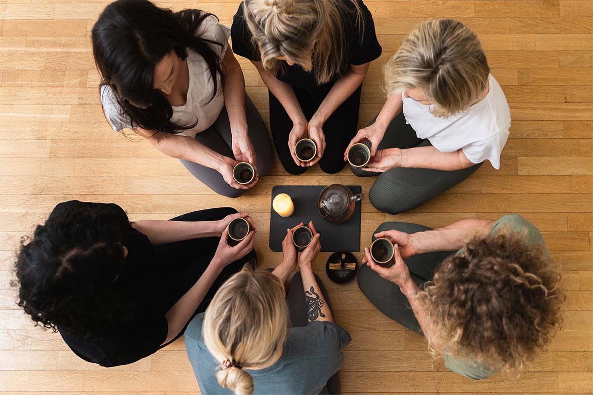 Group of females having coffee at a small table