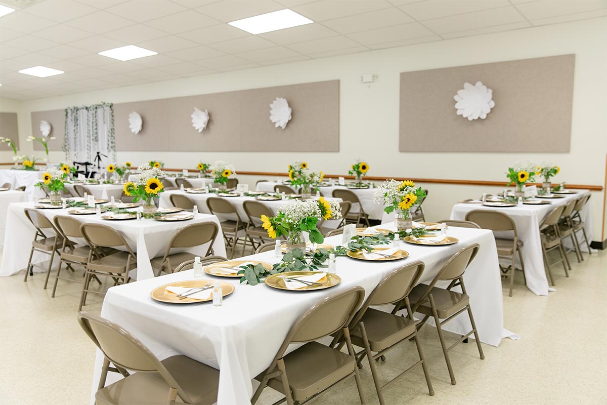 Sunflower centerpieces set on tables with white table cloths