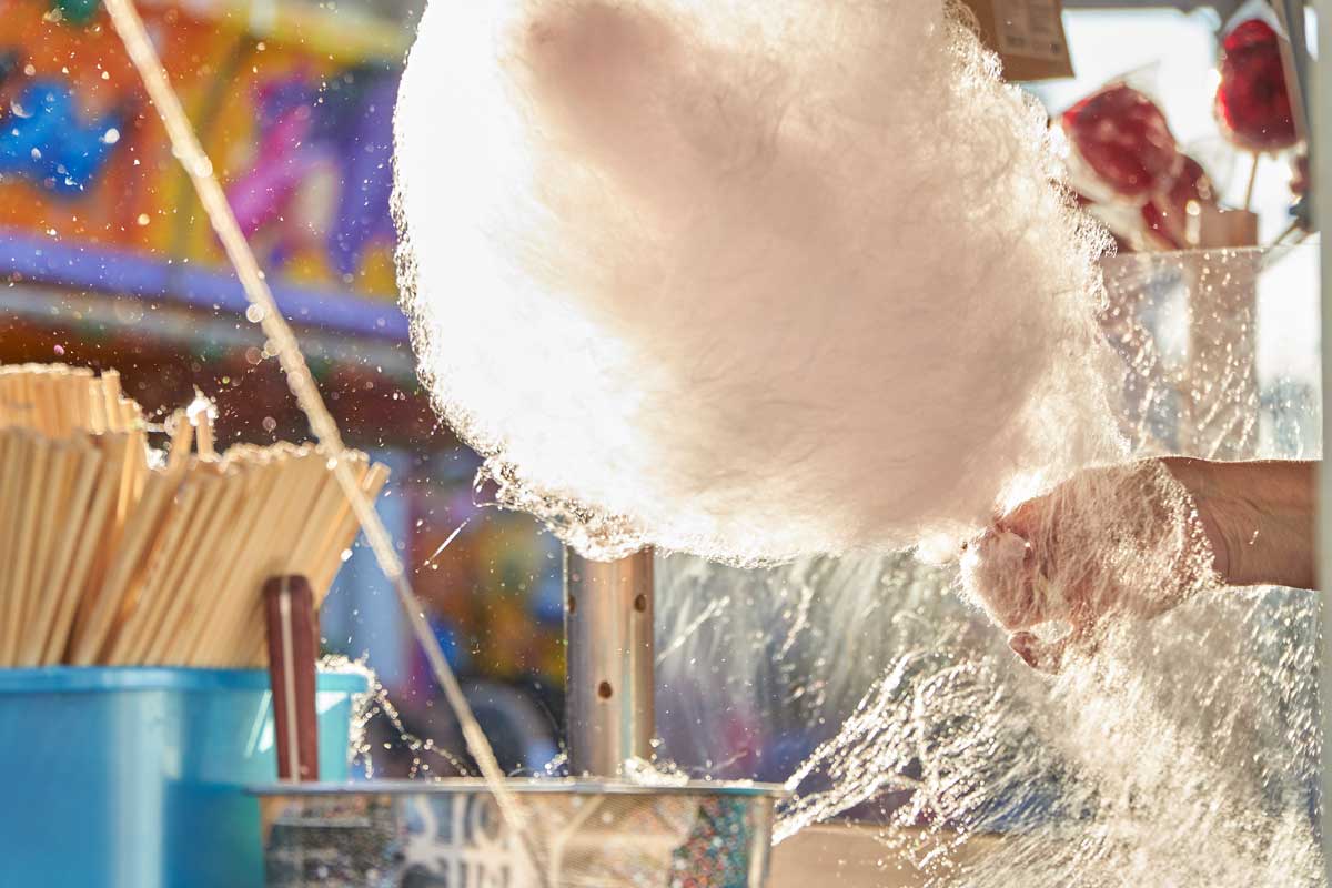 Cotton candy machine with pink cotton candy, adding a whimsical dessert option for the wedding.