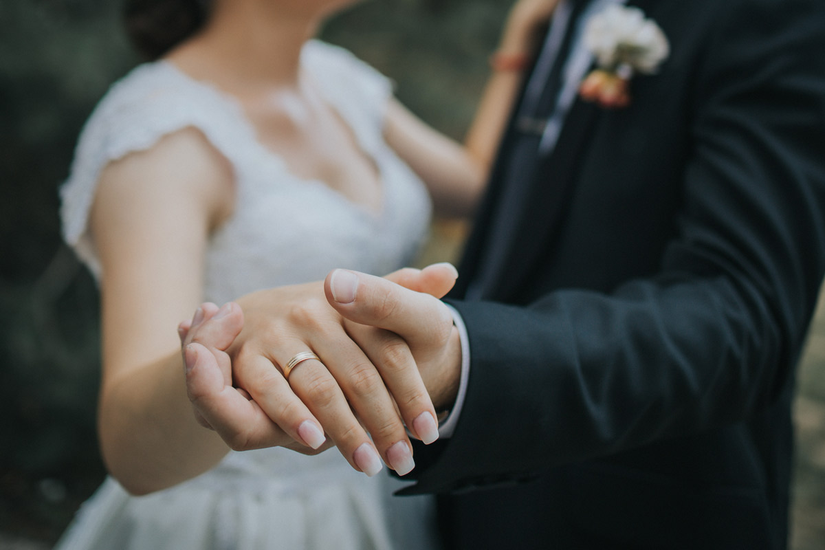 bride and well-dressed man dancing while holding hands