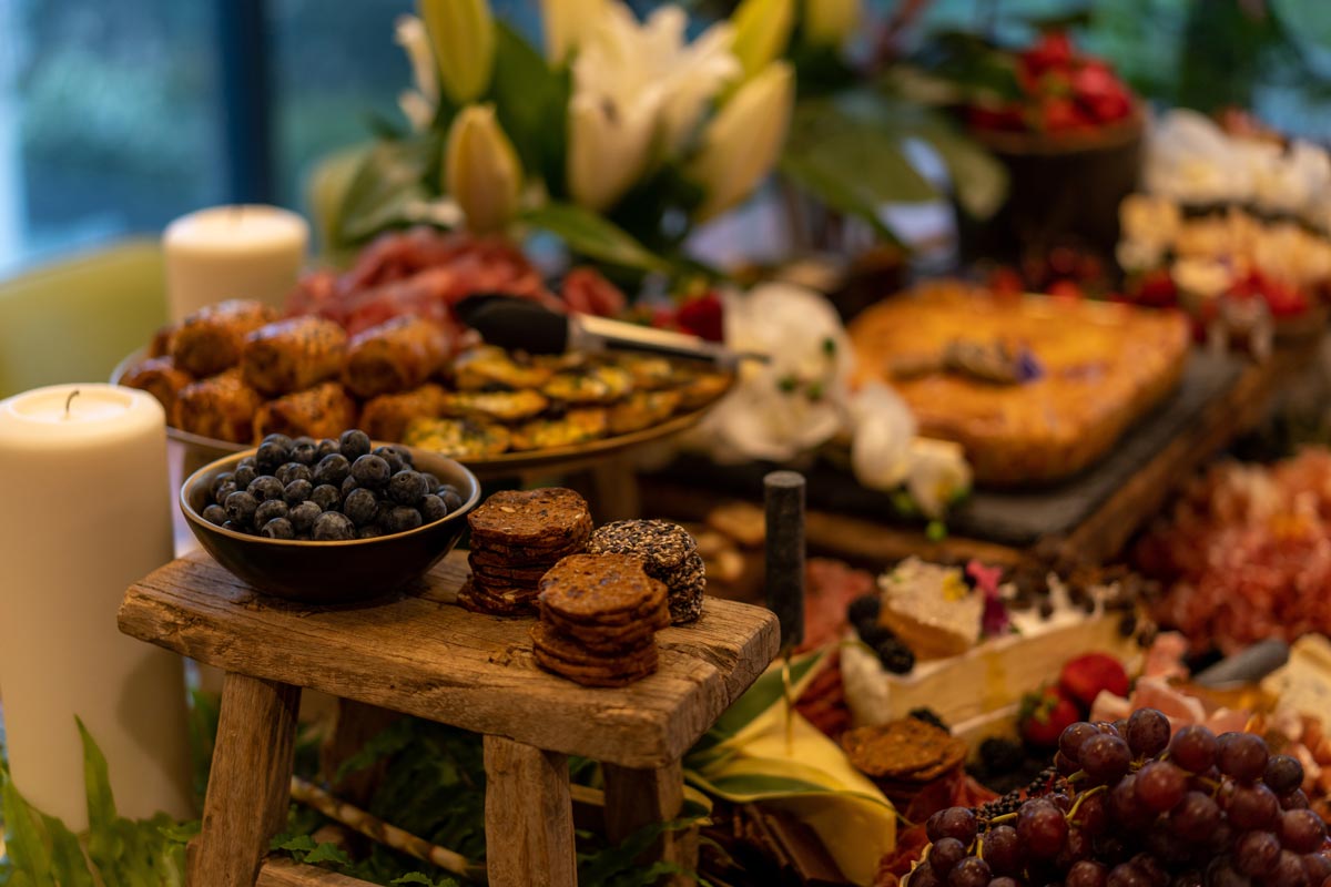 Lots of snacks and appetizers laid out on a table. 