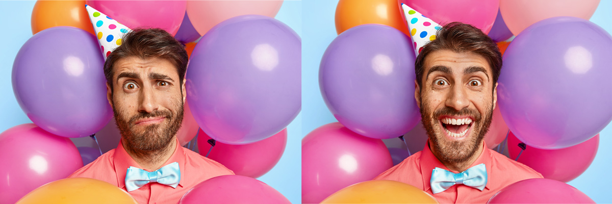 White man in his thirties wearing pink shirt and blue bow tie with birthday hat surrounded by balloons and blue backdrop