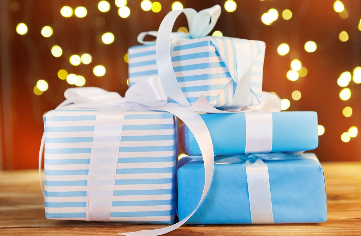 gift boxes on a wooden table with a brown background