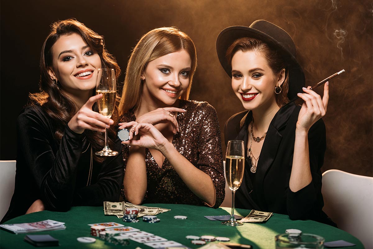 Three females having fun player poker 