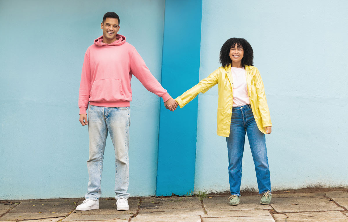 Multiracial couple holding hands and smiling together