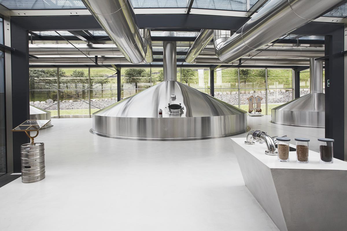 Modern looking brewery with a metal beer tank right in the middle of the room.  