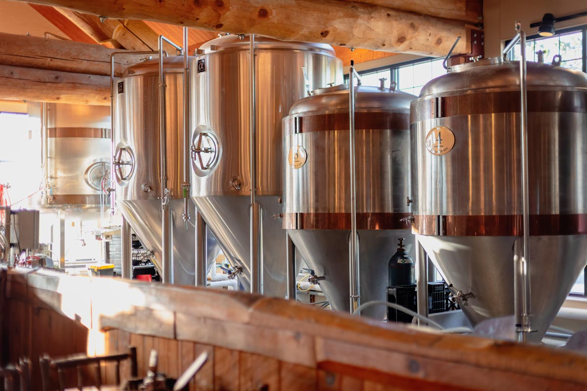 Four metal tanks with beer in them ready to be quality tested. 