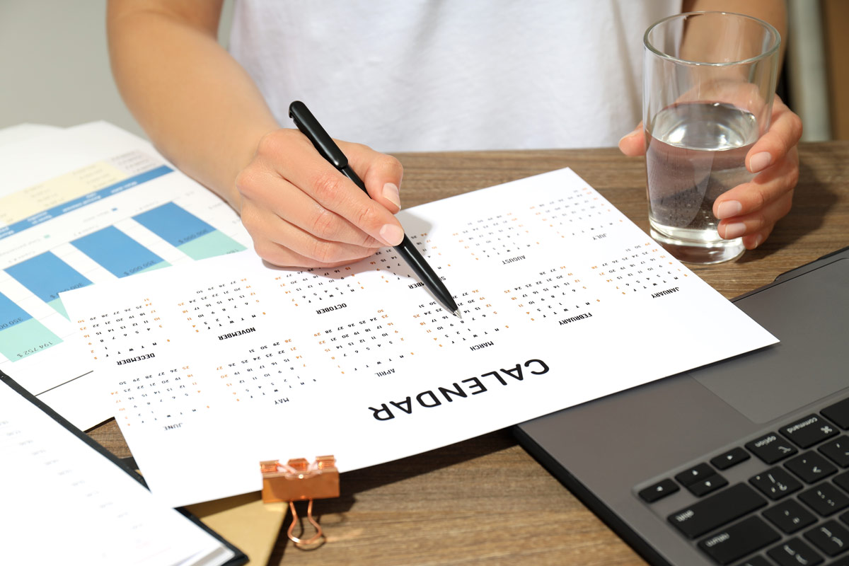 Person checking their schedule determining which date fits best for an appointment. 