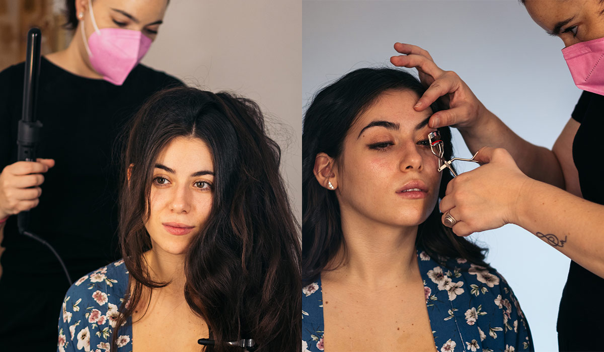 Woman with long hair getting her hair and makeup done by a stylist