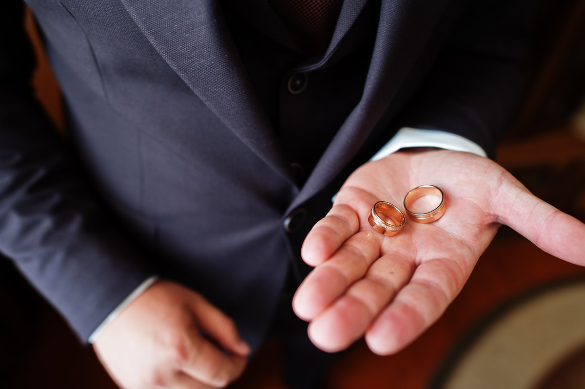 White 20-something-year-old best man getting the rings ready for the wedding. 