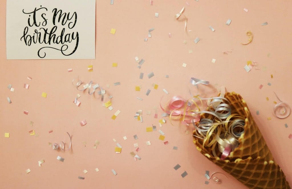 An ice cream cone full of confetti next to a card that says "it's my birthday"