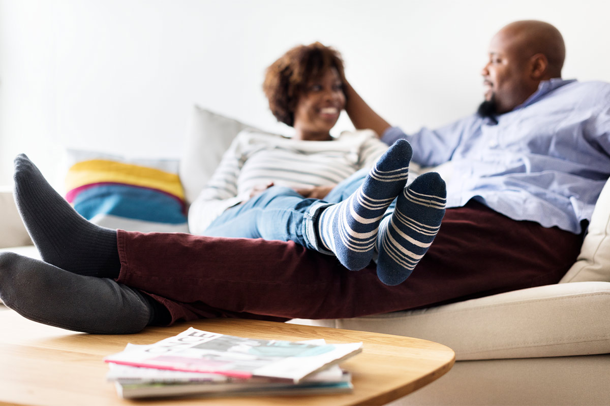 Happy middle age couple relaxing together at home, enjoying each other’s company