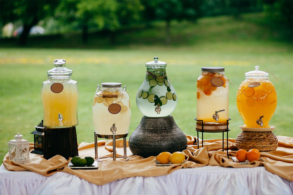 Spread of refreshing drink in jars made with lemons, limes, and oranges on a table 