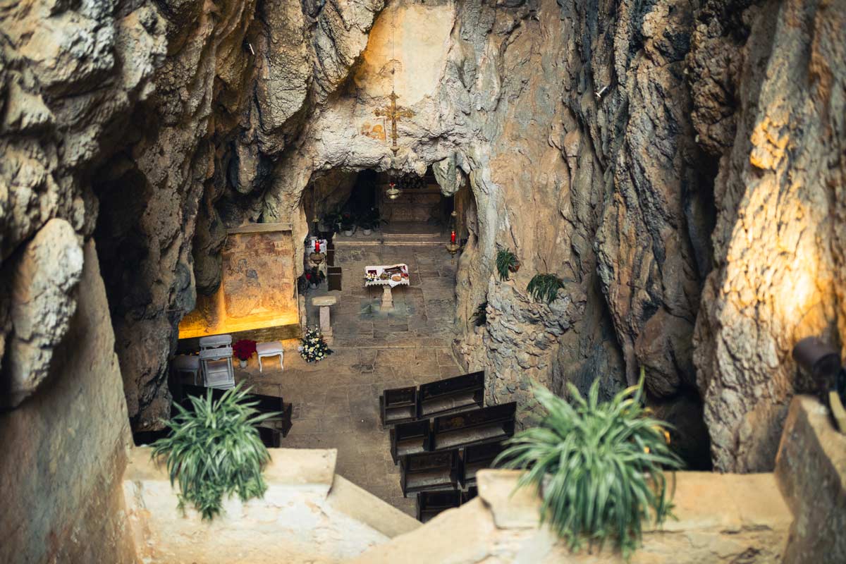 Wedding ceremony setup sits at the bottom of a cave