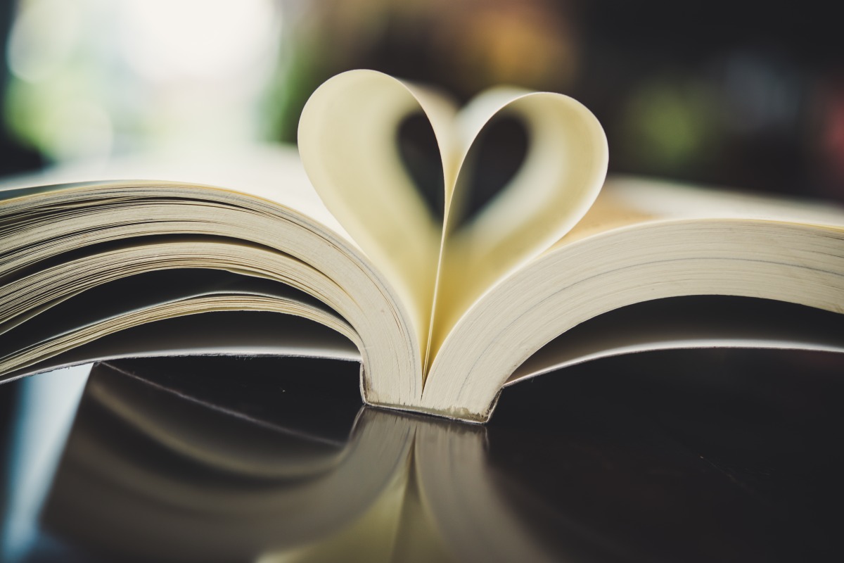 book opened with pages folded into a heart