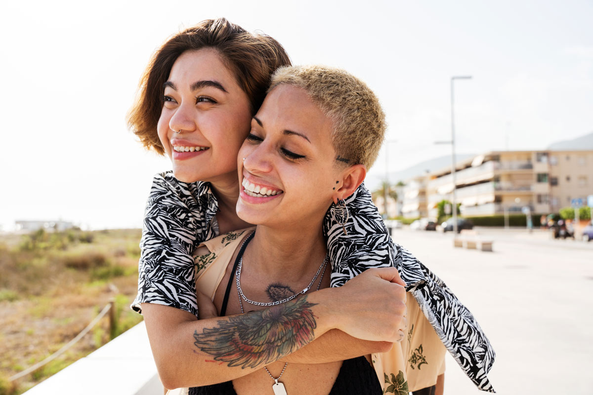 Female couple both smiling together 