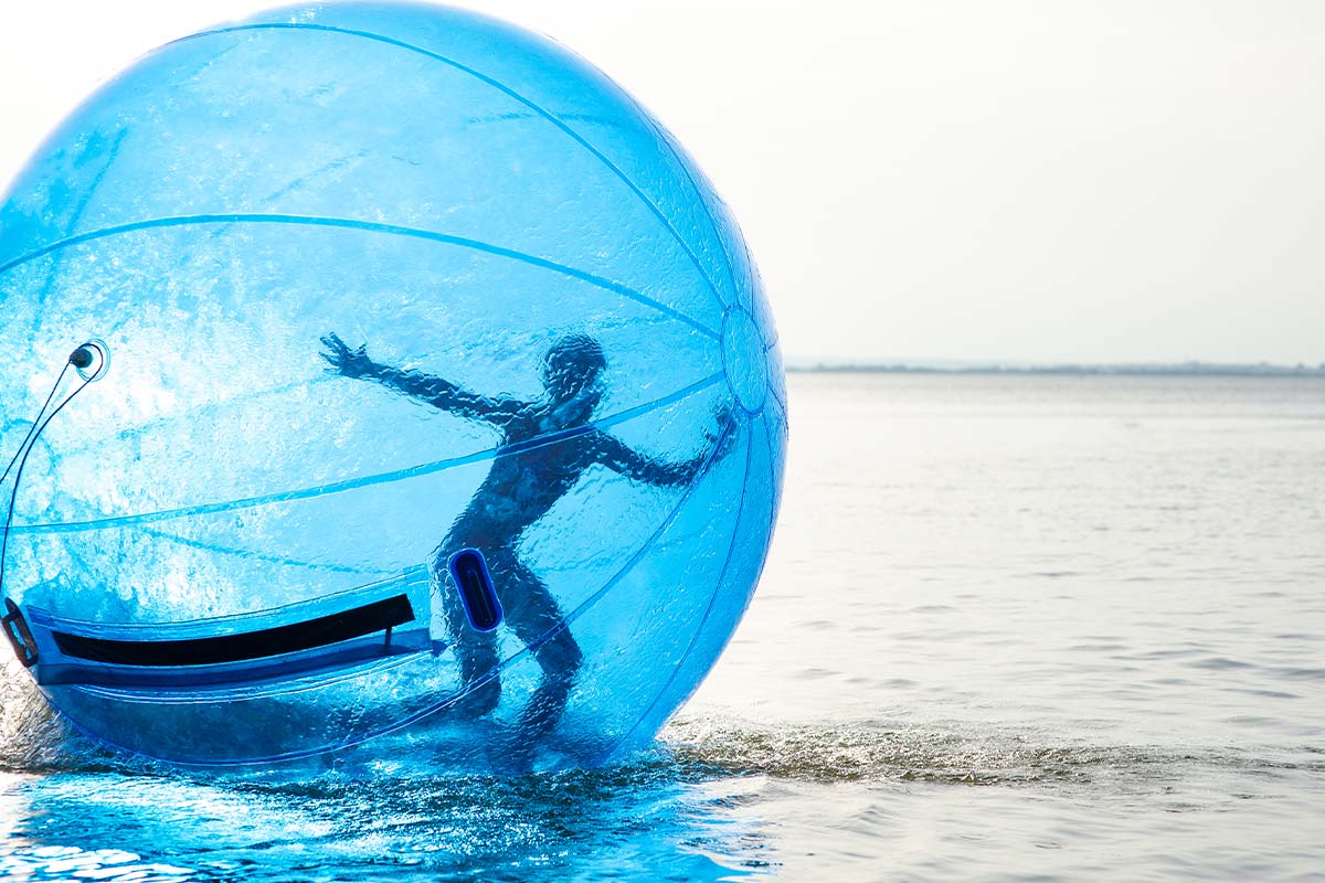 A blue zorb ball over a big body of water