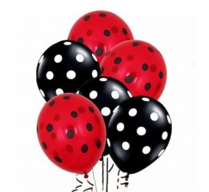 A couple of lady bug themed party balloons