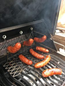 an image of sausages being grilled